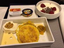 Cheese, some sort of pancake, yogurt with raspberry
