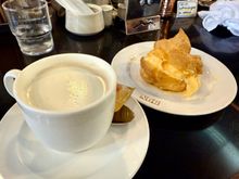 The milk of my cafe au leit was heated on the stove, with a dollop of cream added at the end. The cream puff was constructed for our order.