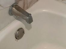 Retro tub faucet handle, accompanied by grout mildew