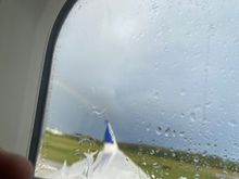 It almost looks like the rainbow is shooting off from the wing!