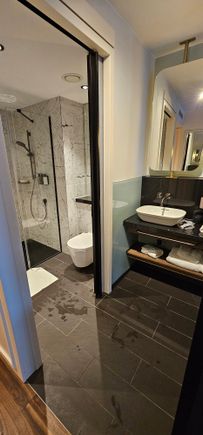 Separate sink and toilet / shower areas.  Sliding door separates them, but cant be locked