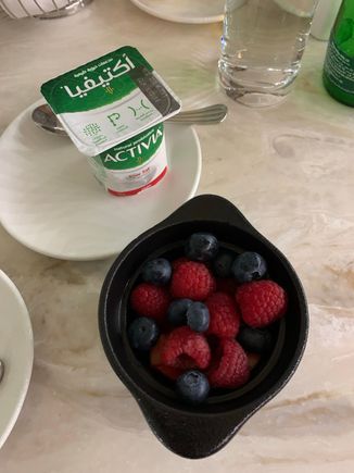Berries, yogurt, sparkling water and an Americano.