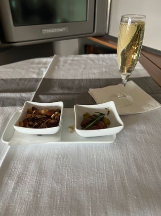 Brought out shortly after wheels up. The FAs were cognizant that folks wanted to sleep, but the service didn’t feel rushed. 

The new champagne (a blanc de blanc) is pretty good and a step up from the Charles de Cazanove. Not on par with the Palmes d’Or that was randomly served last year (out of a plastic cup) or LPGS, but it’s good. 
