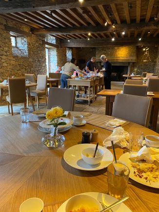 Cleaning up breakfast at Domaine des Etangs in the restaurant with a small but high quality buffet.