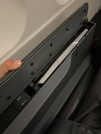 Tray table opens if you press the latch. Better design 