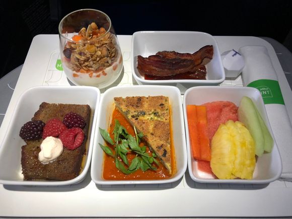 Clockwise from top left: yogurt parfait, maple glazed bacon, fresh fruit, sausage strata, spiced banana French toast