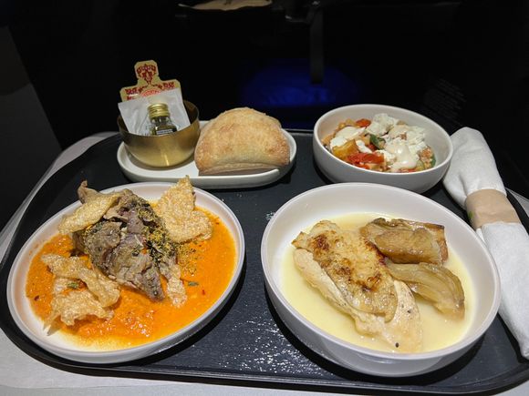 Warm bread, bulgar salad, roast chicken, and pork shoulder.