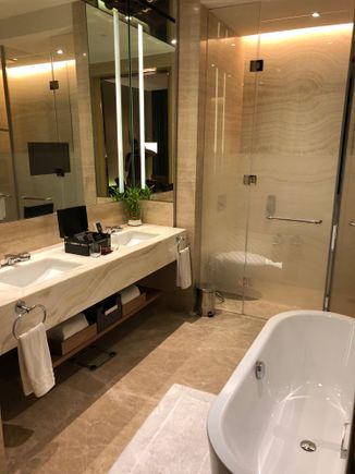 Bathroom with double sink, bathtub and rain shower