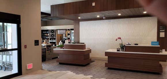 Checkin desk and pantry, with main entrance to the left, and elevators to the right