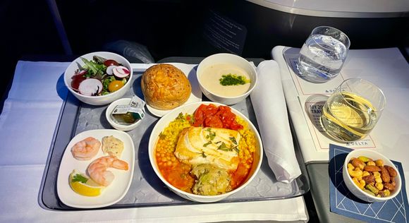 Everything was served at once due to delayed start because of turbulence. Fish was bland but overall edible  