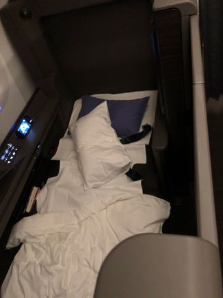 The flight attendants woke me up about 2 hours before landing, and it was only now that I realized that there are actual doors that slide closed to the suite! I rushed to set up a picture before they came back to clean up the bed itself.