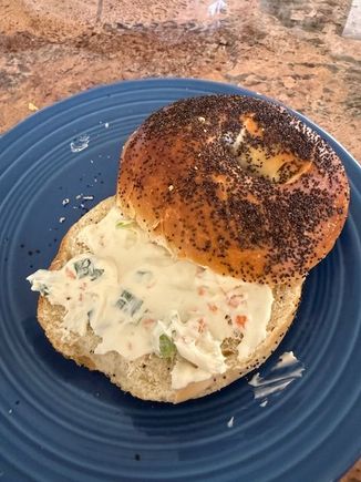 Fresh just baked Poppy seed bagel with their veggie cream cheese. Eaten the way it was meant to be - untoasted. Crisp on the outside, chewy inside. Bagel perfection. 