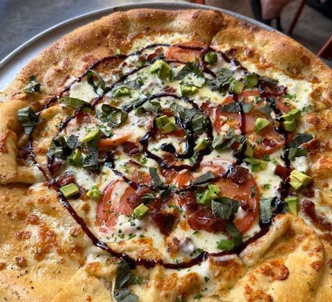 Bacon avocado Margherita pizza with a balsamic reduction drizzle, at Kauai Island Brewing Company. 