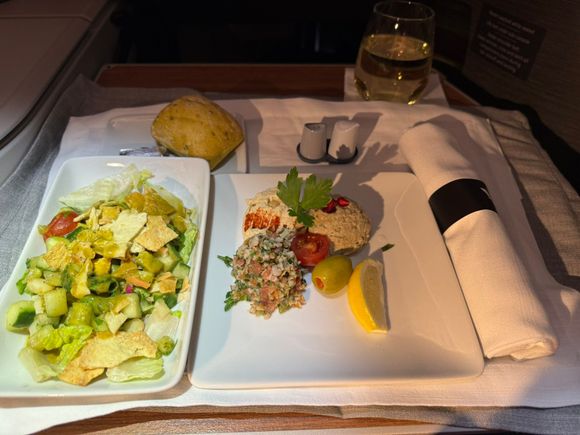 The Moutable, Hummus, and Tabouli was cold and not very flavorful.  There was naan in the bread basket (which I thought was aimed at people with the Indian meal), but I didn't think about it when the F/A presented the breadbasket.  Without a proper bread vehicle, I ate appetizers with a spoon.  Qatar Airways gives you pita squares plus a choice of non-Middle Eastern bread when you get the Middle Eastern starters.  The lemon dressing on the salad was good.