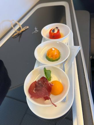 Canapes - bresaola with melon, smoked salmon with cream cheese and cucumber, fire roasted red pepper roulade with goat’s cheese