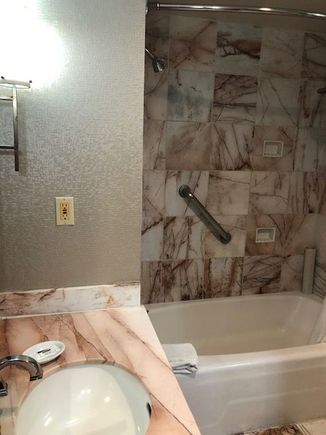Bathroom with tub-shower combo.