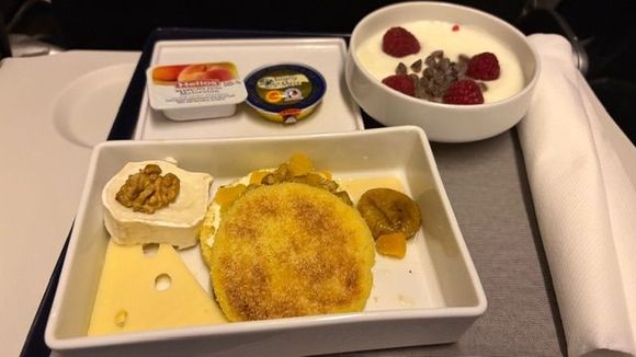 Cheese, some sort of pancake, yogurt with raspberry