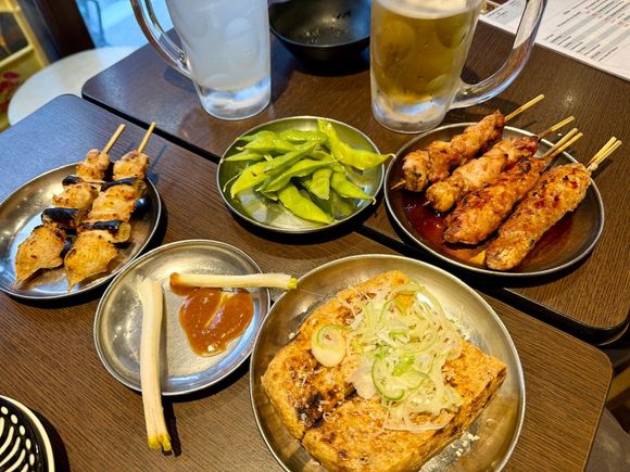 Pork yakitori, shallots, edemame (eaten), chicken wing and meatballs, fried tofu. Out of shot: fried rice ball, miso soup, pork tongue.