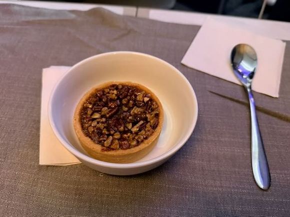Pecan tart, which was supposed to be served warm with ice cream. served cold without ice cream.