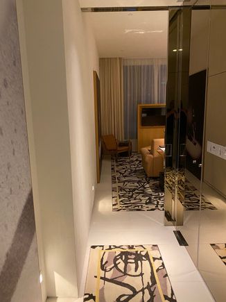Suite entry hallway, lined with a closet and a powder room.