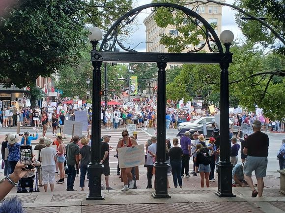 Event was on College Square, across from the iconic UGA arch. At first the crowds were mostly along Broad Street, showing signs to the honking passing cars.