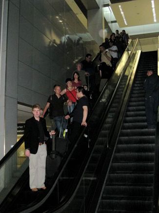 The group on a escalator at SFO.