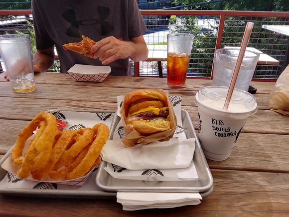 Pre-concert meal of vidalia onion rings, a customized burger and salted-caramel shake at Grindhouse Killer Burgers. 