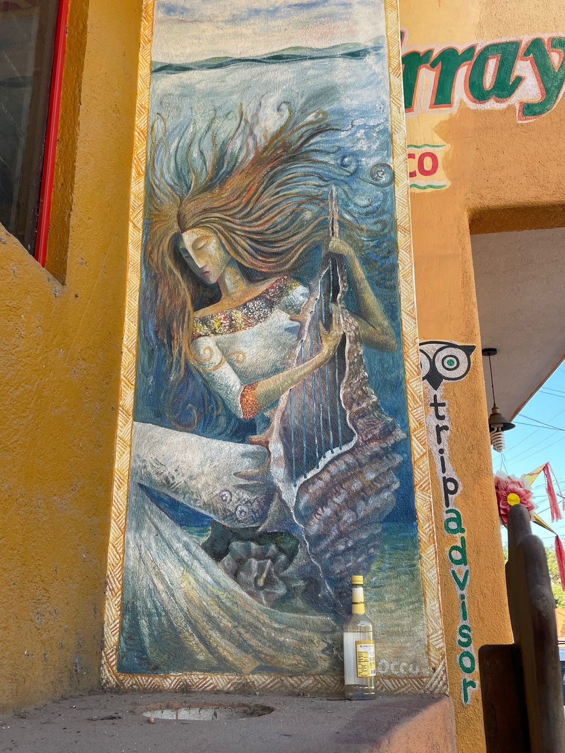 On the side of restaurant on Adelitas street.