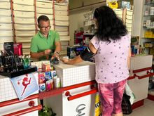 While waiting in line to see pharmacist, I watched him taking blood pressure of young local woman