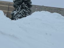 mountains of piled up snow in town.