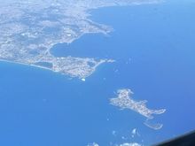 Procida island with Naples on top.