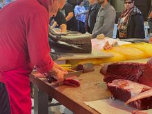 The master cutting tuna (in season) for his customers