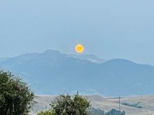 Moonrise last night. Smoke in the air turns the moon orange. 