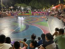 This is the basketball court or the Concha.  Usually entertainment at night, this is a payaso, "clown" entertaining the crowd.