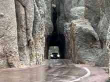 Thje Needles Highway has 2 of these tunnels. I had to fold in the morrors on my pickup. There are signs every couple of miles warning about the narrow tunnel. YET, someone pulling a large camper was heading right for it on our way out of there.