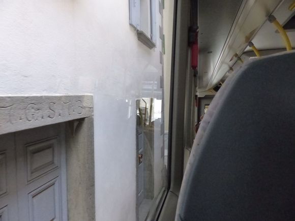 In the bus, passing homes in main street