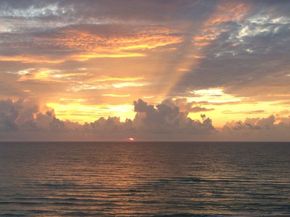 Sunrise this morning. You can just barely see the sun at the base of the clouds, but it was bright red.