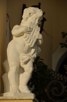 Fira statuary: cherub God Pan.