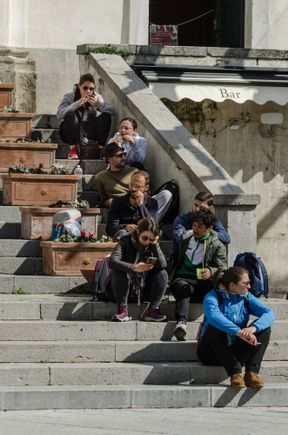 Sitting on the church steps. Locals or visitors?