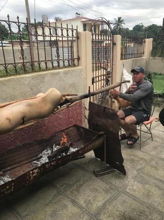 Yordani again turning the pig on the spit early on New Year's Eve (fin de anos). Note that my wife has been busy having our front courtyard wall rebuilt much higher out front of our casa for more privacy - I like it. Still needs some paint to finish it.