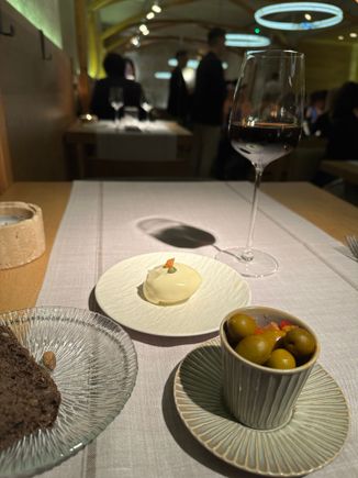 Black bread and delicious olives in the foreground, with that lovely tuna tomato inside cooked egg white concoction....a dish to which diners are "invited," as the menu notes.