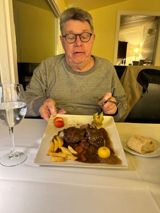 Perplexed diner eyeing his glazed pork cheeks, which he liked very much.