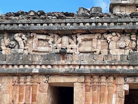 Above the door way is an upside down figure you can see his "frog" legs. I read this is a descending god