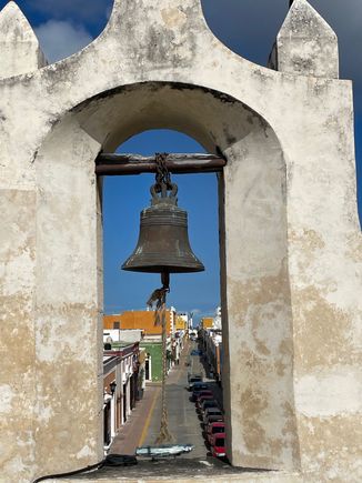I know this looks just like the bell I posted yesterday, but it is actually from the other end of town.  You can almost see the Angel on the Malecon to the right of the bell