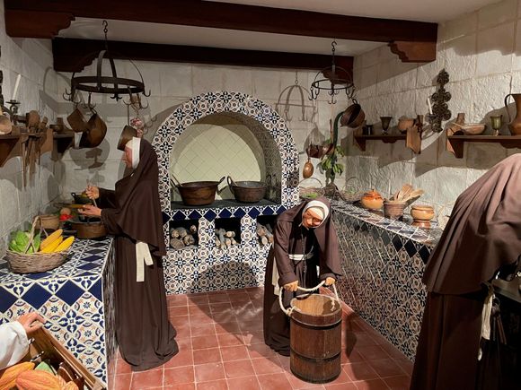 The nuns in the kitchen making and baking with chocolate.