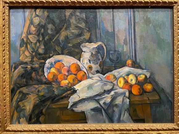 One of the great Cezanne still lifes.  It looks like the peaches are falling out of the plate