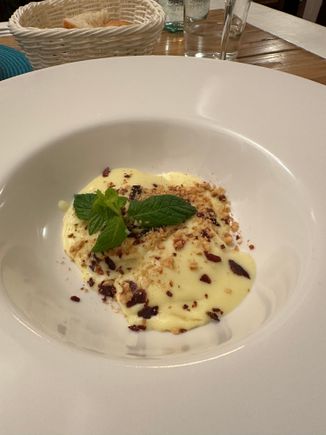 Ravioli stuffed with ricotta di bufala in a creamed potato sauce, topped with bits of hazelnut and crispy guanciale; this is a half portion