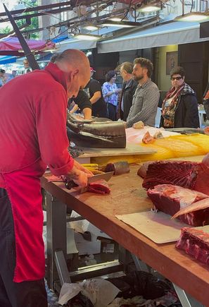 The master cutting tuna (in season) for his customers