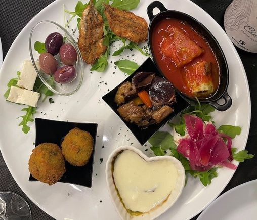 Appetizer sampler for two: feta, olives, fried anchovies, mackerel/carmelized onions, caponata and a few other things