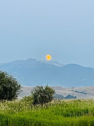 Moonrise last night. Smoke in the air turns the moon orange. 